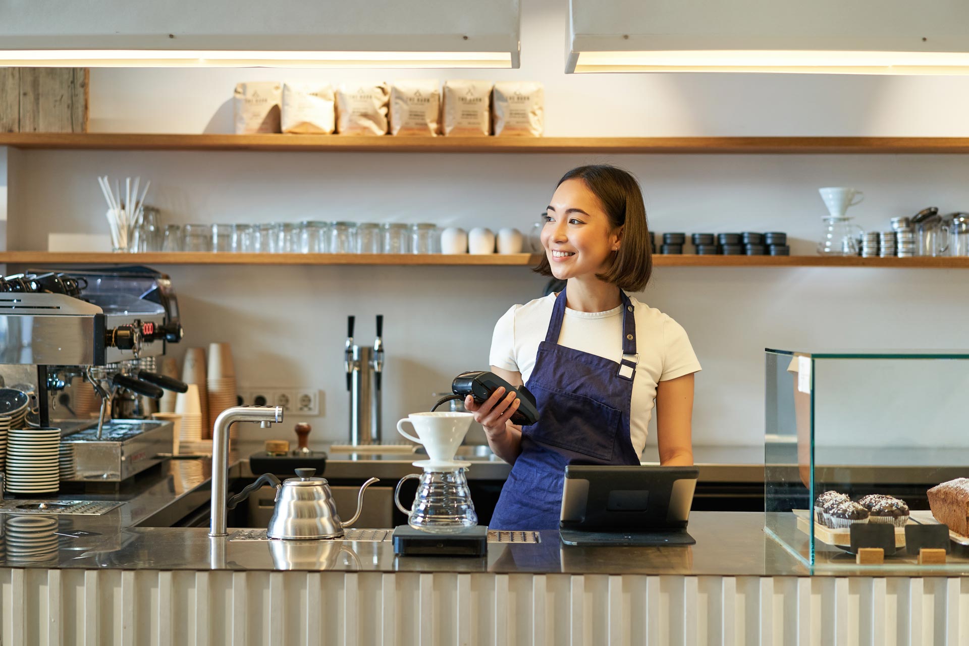 Small business owner taking a payment at her counter